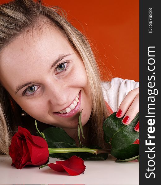 Young woman holding red rose.