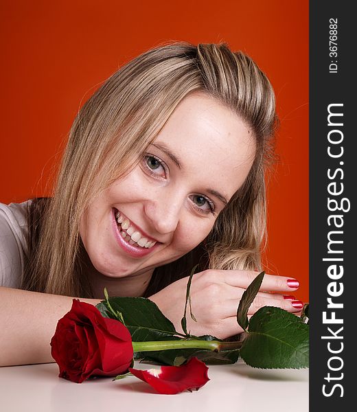Smiling woman with red rose