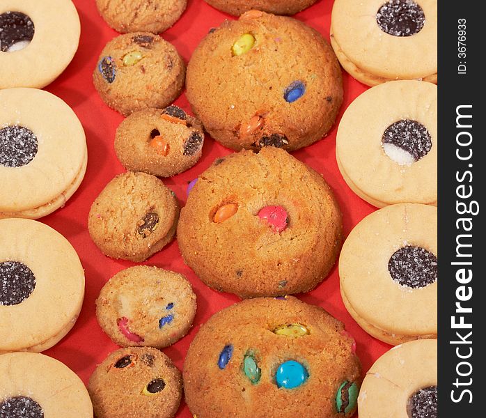 Different variety of cookies over a red background. Different variety of cookies over a red background