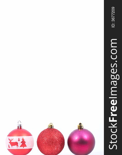 Three christmas balls over a white background