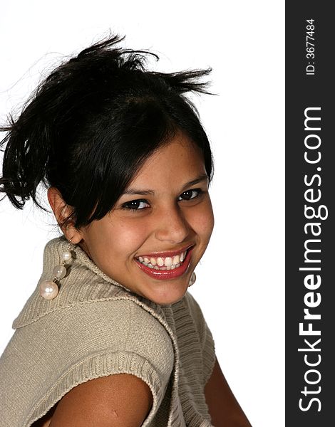 Portrait of cute young Hispanic woman wearing a beige sweater with her long black hair up. Portrait of cute young Hispanic woman wearing a beige sweater with her long black hair up