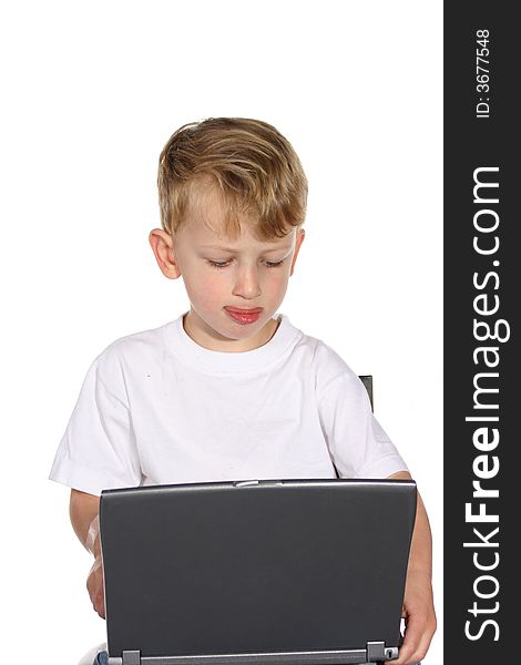 Cute little boy working on a laptop computer. Cute little boy working on a laptop computer