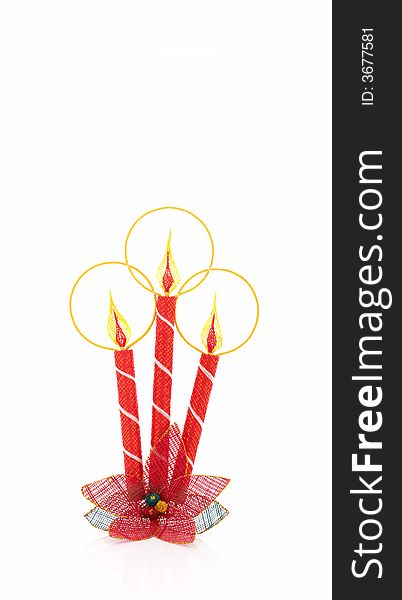 A christmas candle decoration over a white background