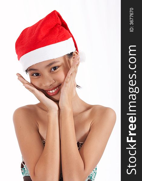 A girl wearing a christmas hat over a white background. A girl wearing a christmas hat over a white background