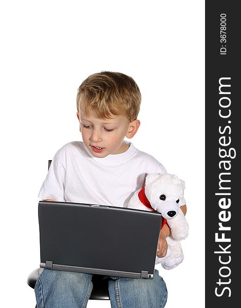 Cute little boy working on a laptop computer. Cute little boy working on a laptop computer