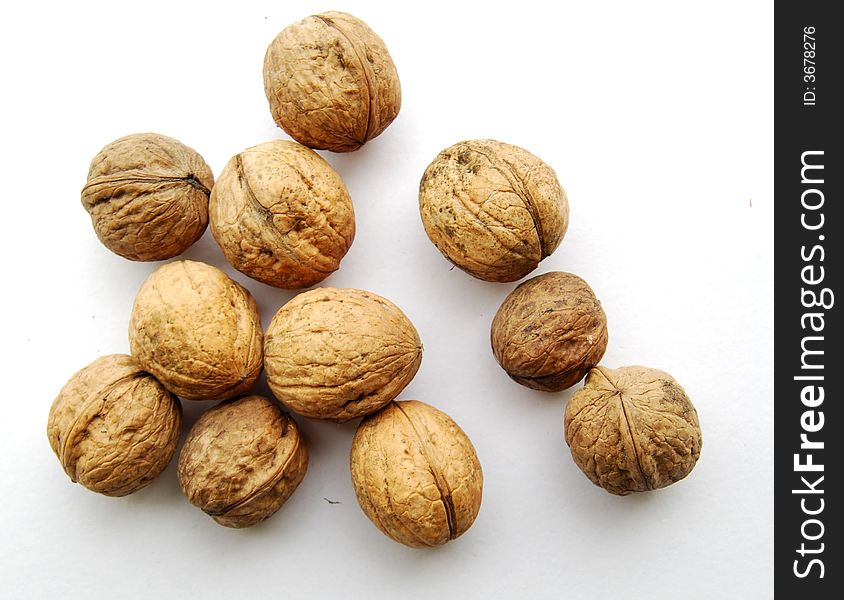 Eleven walnuts on white