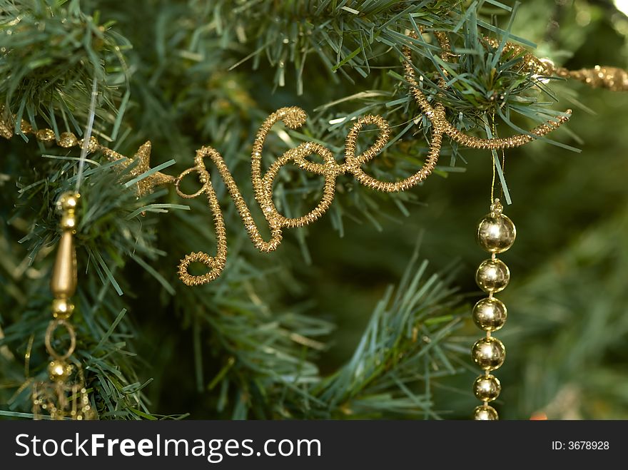 Macro of Christmas' decoration against a christmas' tree background