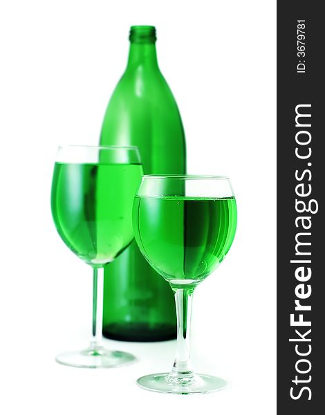 Green drink bottle and glasses over white background