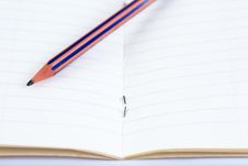 Pencil On Opened Lined Notebook Stock Images