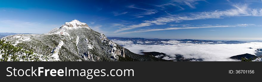 Mountain peak over a sea of clouds in winter
