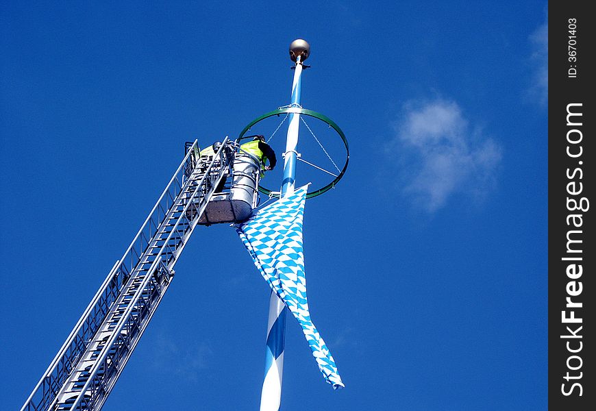 Two workers are working at height in Bavaria in Germany. Two workers are working at height in Bavaria in Germany.