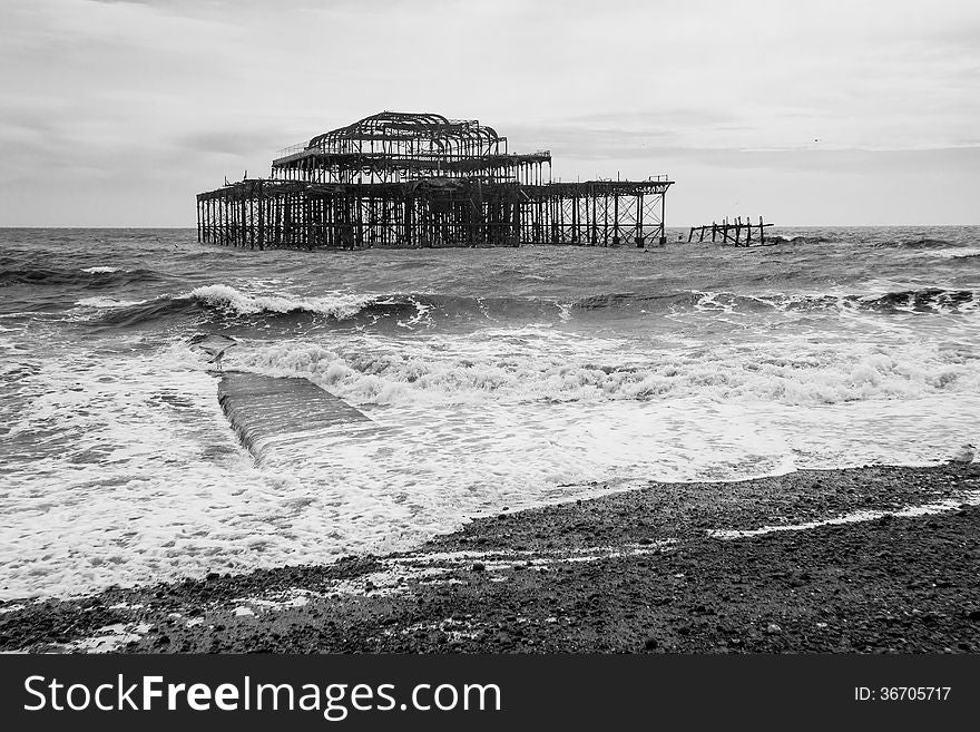 Black and white shot of the West Pier, Brighton, England. Taken on a stormy day. The pier lay derelict for years before being destroyed by fire, leaving and empty shell. Black and white shot of the West Pier, Brighton, England. Taken on a stormy day. The pier lay derelict for years before being destroyed by fire, leaving and empty shell