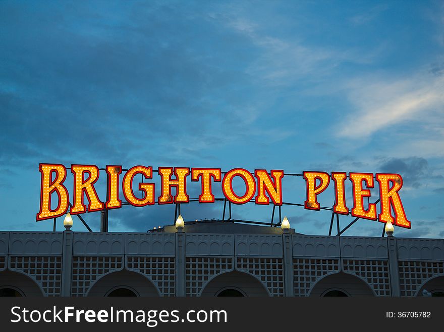Illuminated Brighton Pier sign at the entrance to the pier, taken in the evening. Illuminated Brighton Pier sign at the entrance to the pier, taken in the evening.