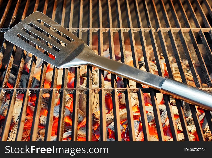 Burning charcoal in BBQ facilities and utensils on a hot grill. Burning charcoal in BBQ facilities and utensils on a hot grill