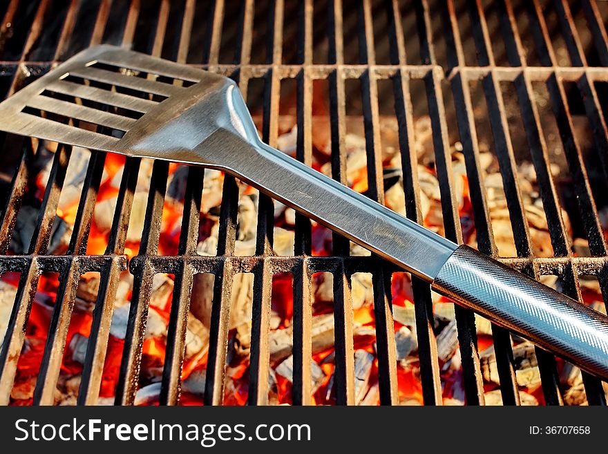 Burning charcoal in BBQ facilities and utensils on a hot grill. Burning charcoal in BBQ facilities and utensils on a hot grill