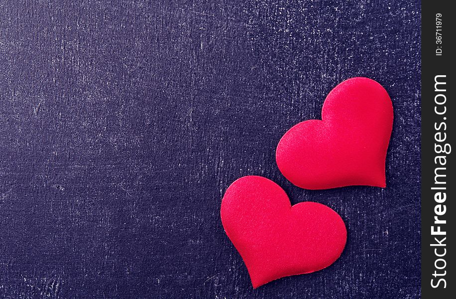 Two Red Hearts On A Black Board