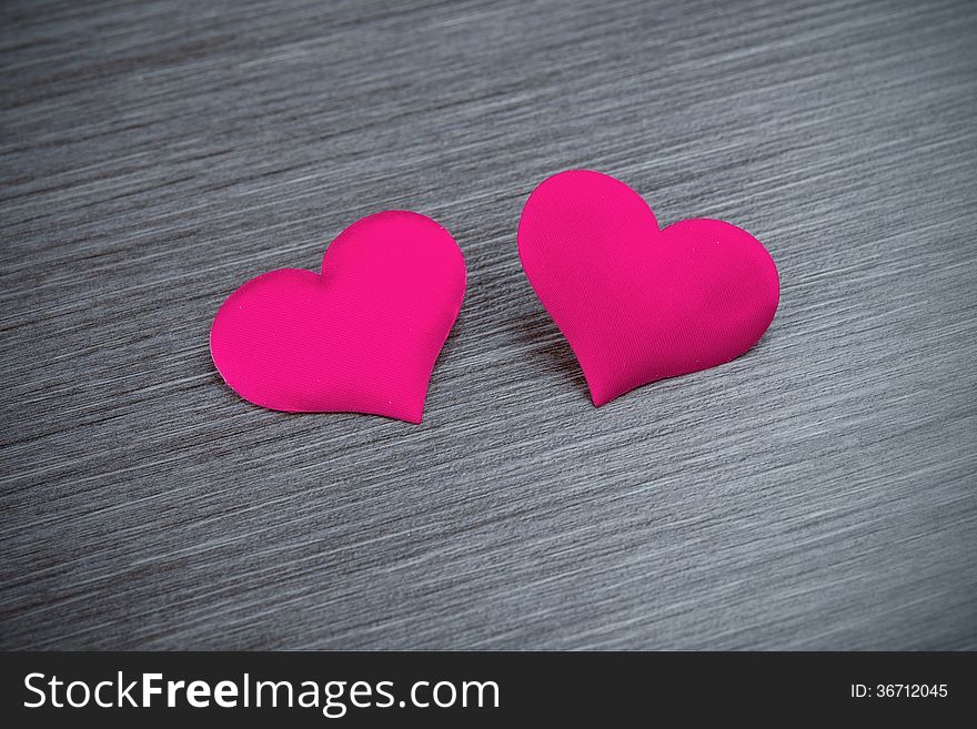 Valentine card. two red hearts on a black board