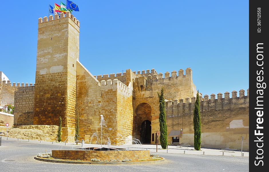 Gate alcazar with a fountain in the foreground, Carmona, Seville (Spain)