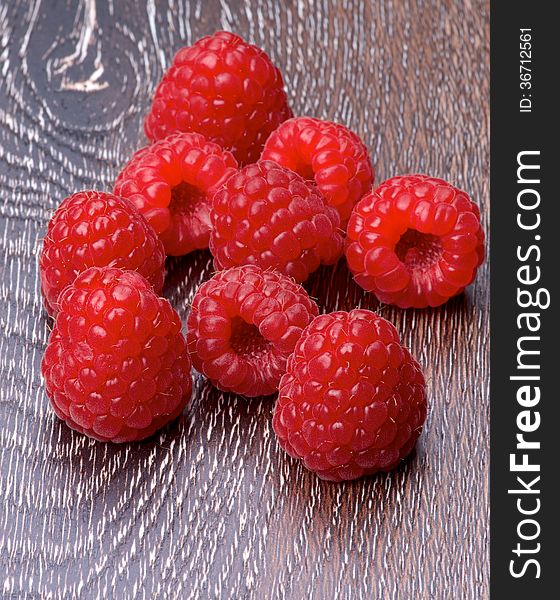 Heap of Fresh Ripe Raspberries isolated on Hardwood background