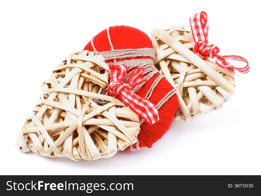 Arrangement of Three Handmade Wicker and Textile Valentine Hearts Overlapped isolated on white background