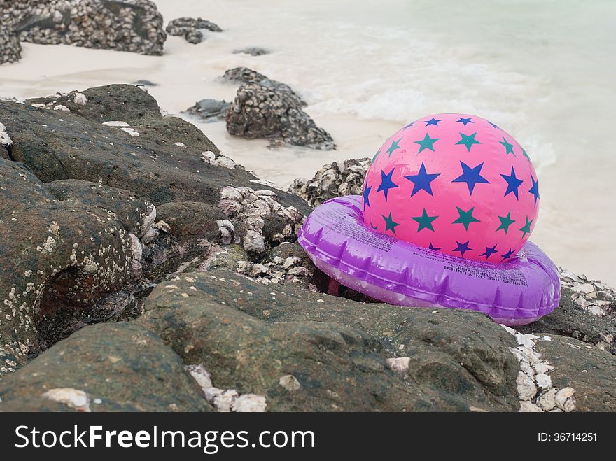Background with a beach ball in the sand.