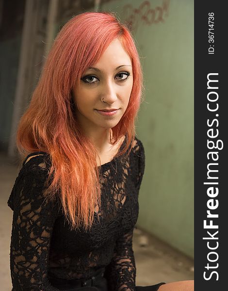 Beautiful young red haired model posing in abandoned buildings. Beautiful young red haired model posing in abandoned buildings