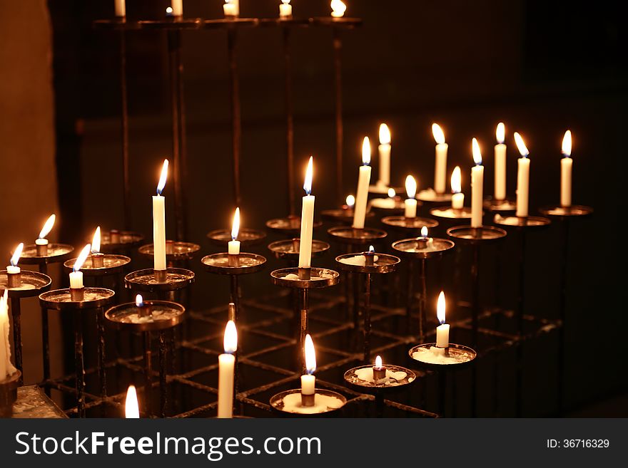 Religion concept. Set of lighting candles in church