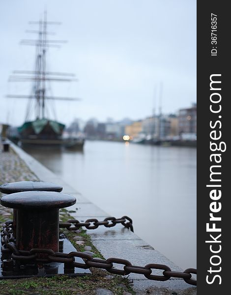 Nice sailing ship near granite embankment. Evening in Turku, Finland