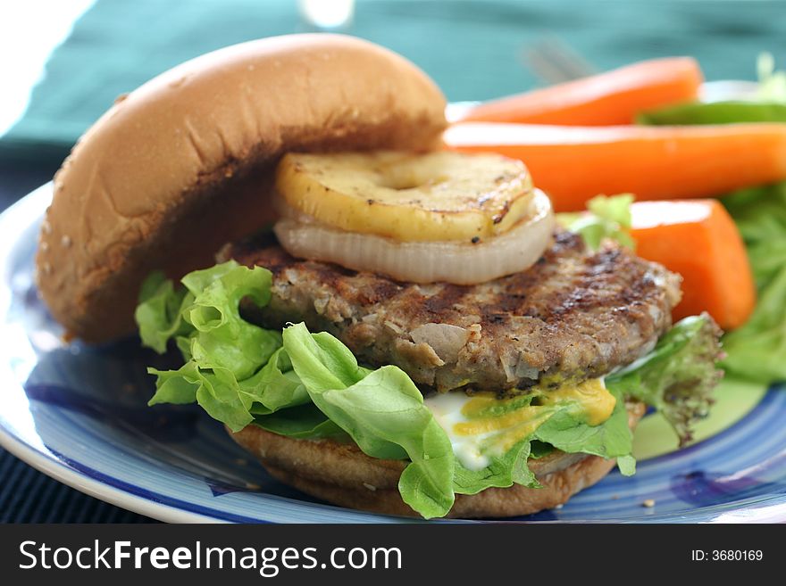 Healthier homemade grilled burger with carrots and plenty vegetables