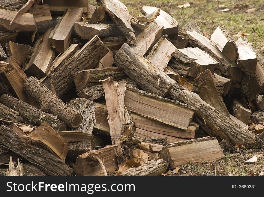 Chopped wood gathered in a pile outdoors. Chopped wood gathered in a pile outdoors.