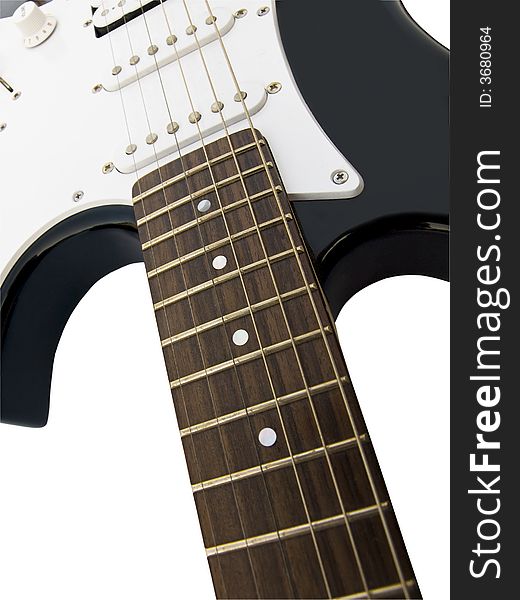 Black acoustic guitar with wooden fingerboard close-up, over white