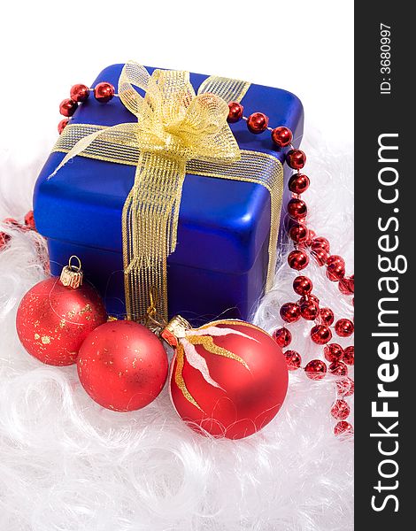 Red christmas balls and red beads, blue box with gift. Red christmas balls and red beads, blue box with gift