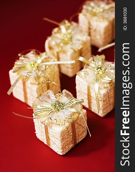 Small boxes with gifts on red background, low DOF. Small boxes with gifts on red background, low DOF