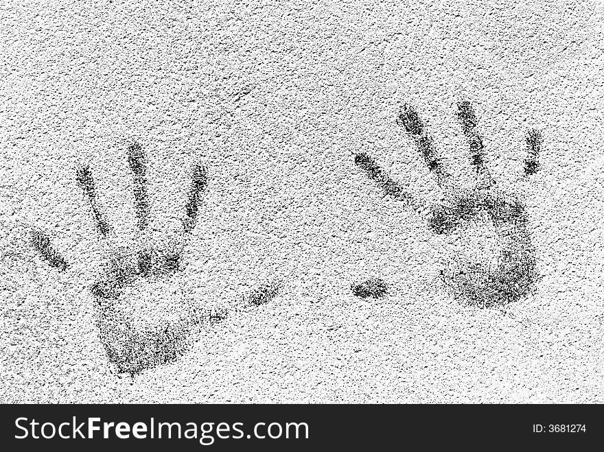 Detailed closeup of black handprints on textured white wall. Detailed closeup of black handprints on textured white wall