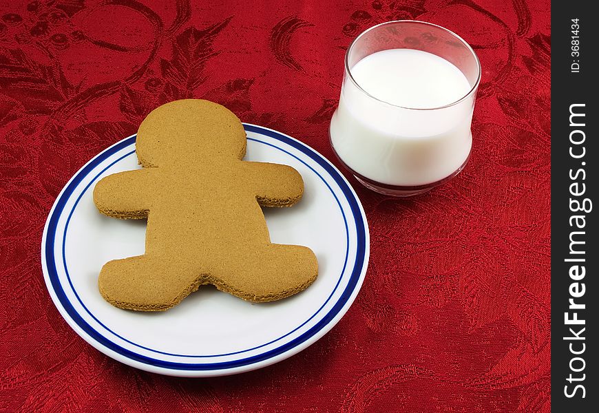 Gingerbread cookie and a glass of milk left for santa
