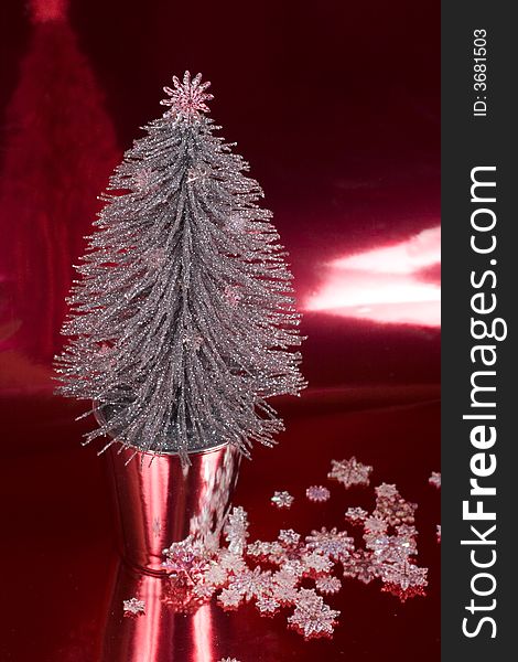 Silver Christmas Tree on a silver red background with snowflakes.