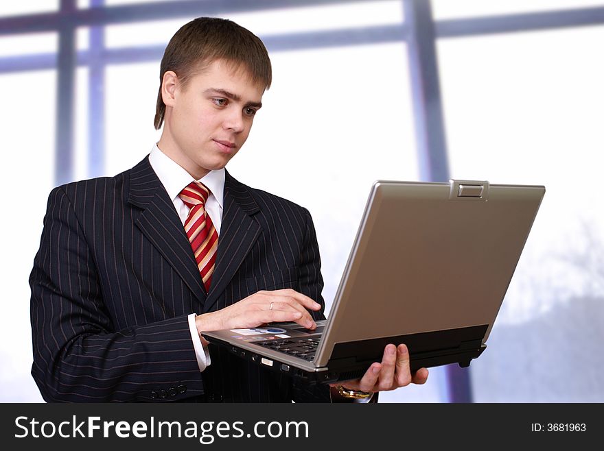 Cheerful businessman with laptop computer
