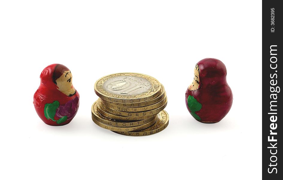 Two wooden dolls divide coins. Two wooden dolls divide coins.