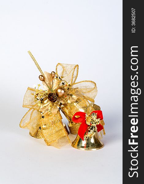 Golden christmas bell with a big golden ribbon isolated. Golden christmas bell with a big golden ribbon isolated