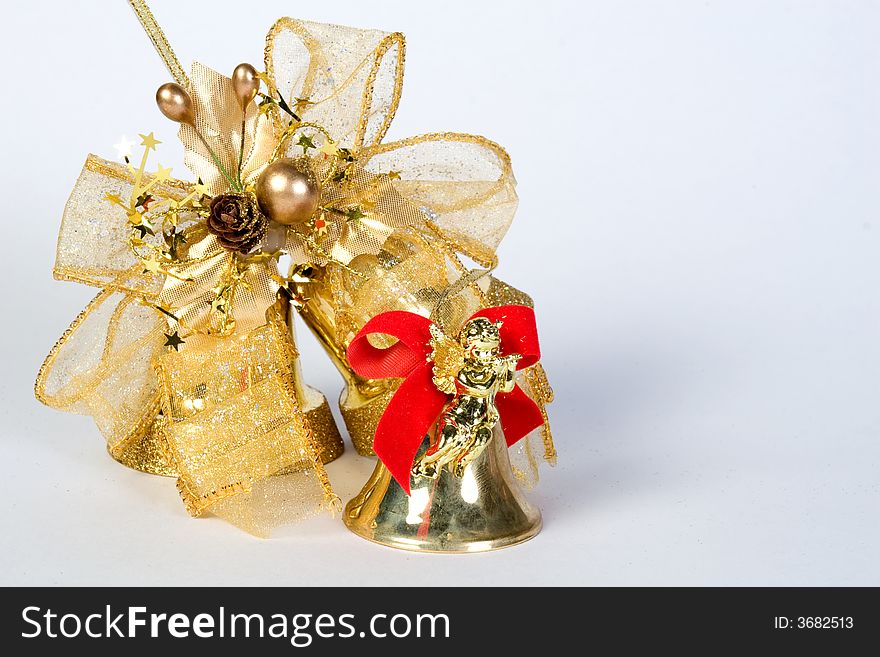 Small christmas bell with angle and a big ribbon isolated. Small christmas bell with angle and a big ribbon isolated