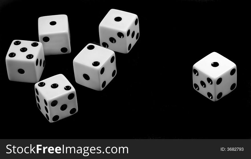 Dice tossed onto a black surface. Dice tossed onto a black surface.