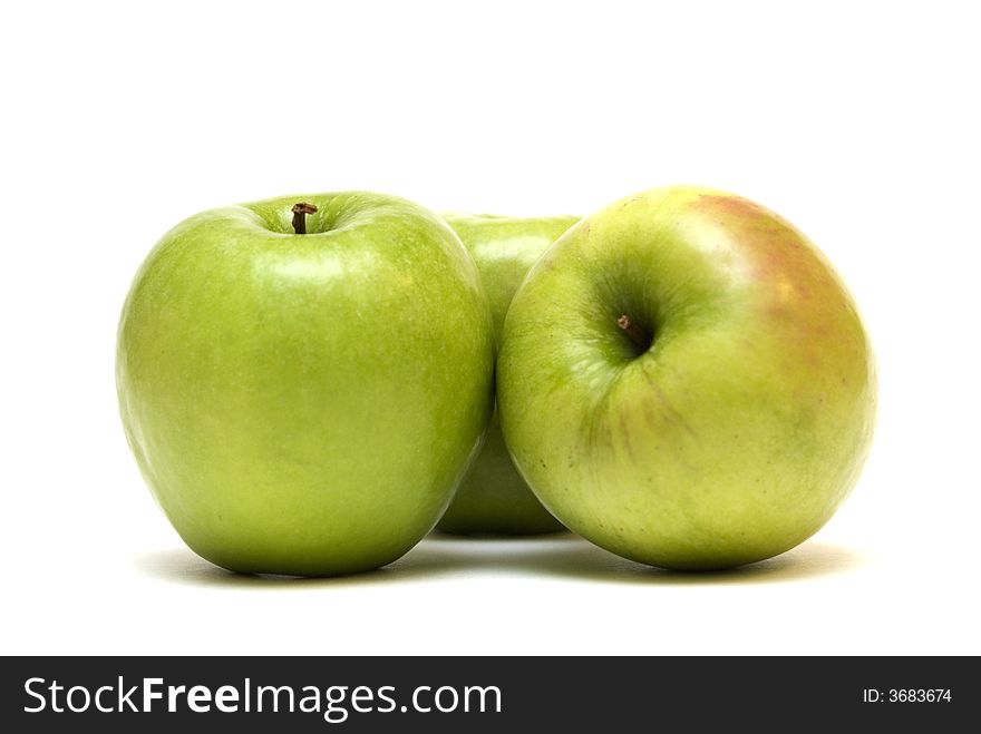 Three green apples on the white background