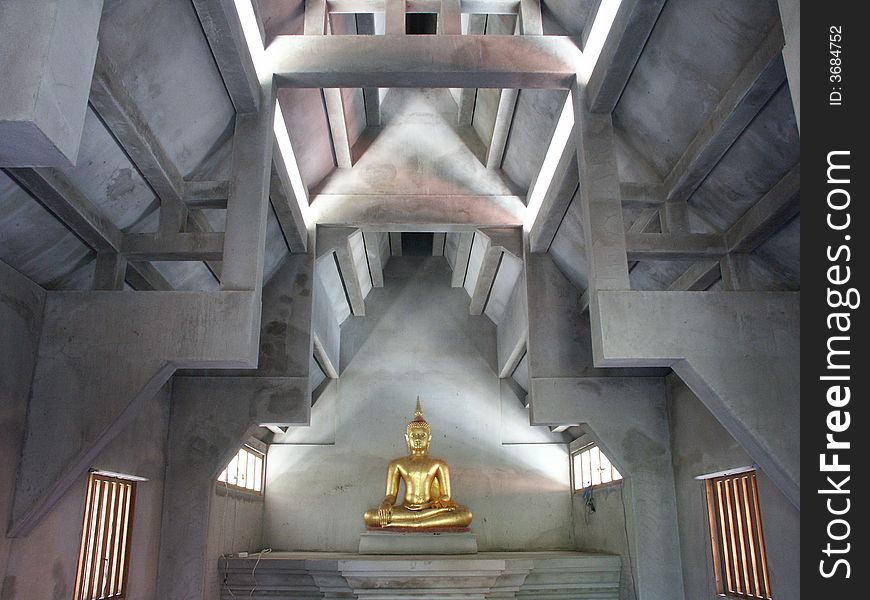 Standing golden Buddha image on the meditation institute.