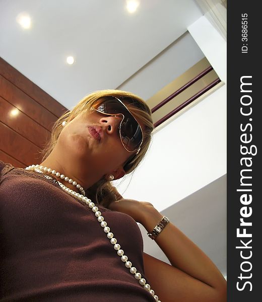 Young Girl with a necklace and sunglasses. Young Girl with a necklace and sunglasses