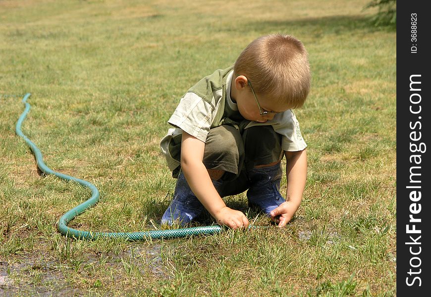 Boy plays with tools in the garden. Boy plays with tools in the garden