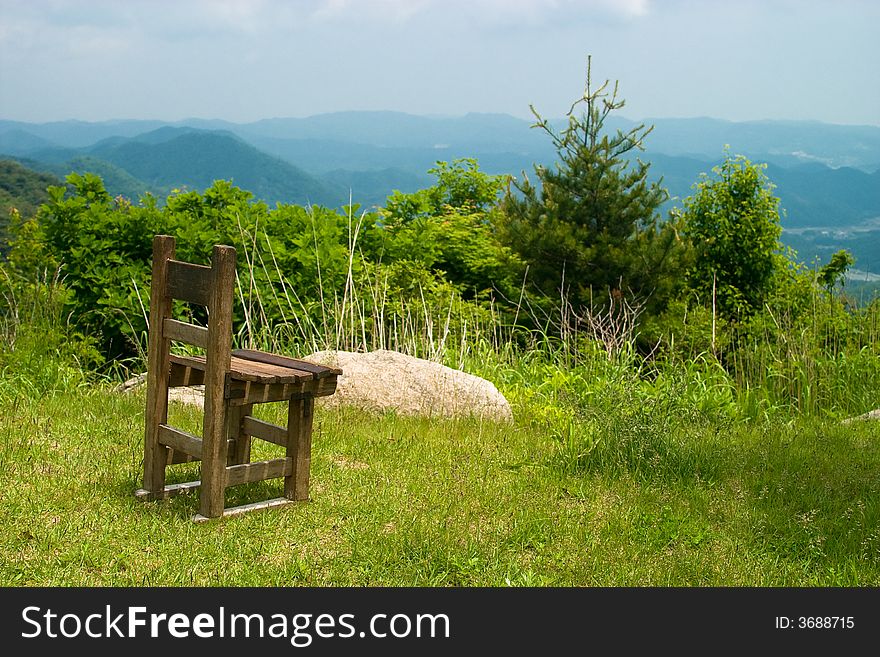 Retro wooden chair located at mountain cliff. Retro wooden chair located at mountain cliff