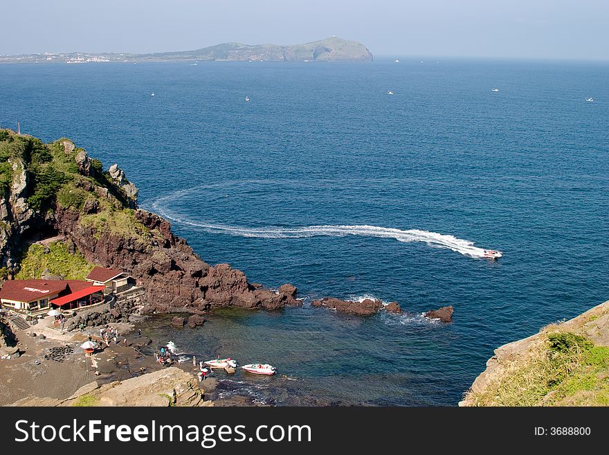 View on rocky bay with black sand for speed boat. View on rocky bay with black sand for speed boat