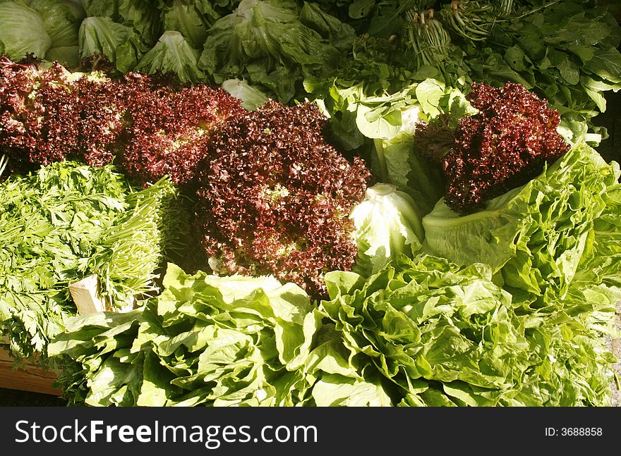 Red and green lettuce on a market stall