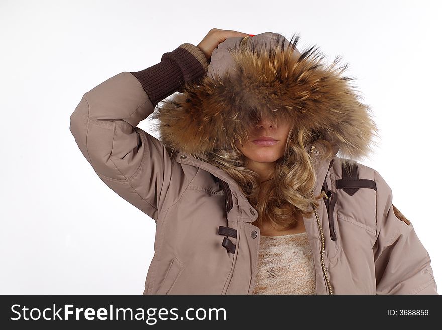 The girl in a beige jacket, in a hood with fur