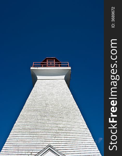 Upward shot of lighthouse with blue skies - great contrast of texture and colour. Upward shot of lighthouse with blue skies - great contrast of texture and colour